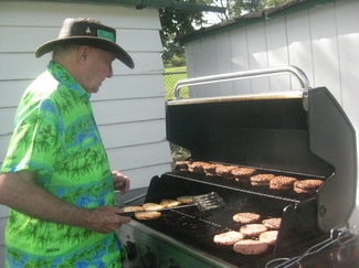 a member cooking a Fun Day lunch on the grill