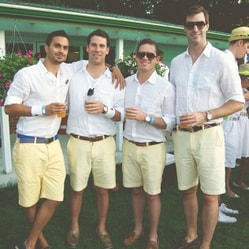 Four young men with drinks in hand  at Lawn Summer Nights event